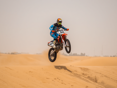 Dirt bike motorcycle rider jumping over desert dunes in Dubai, extreme sports action, motocross in sand, high jump, thrilling adventure, professional photography (2)